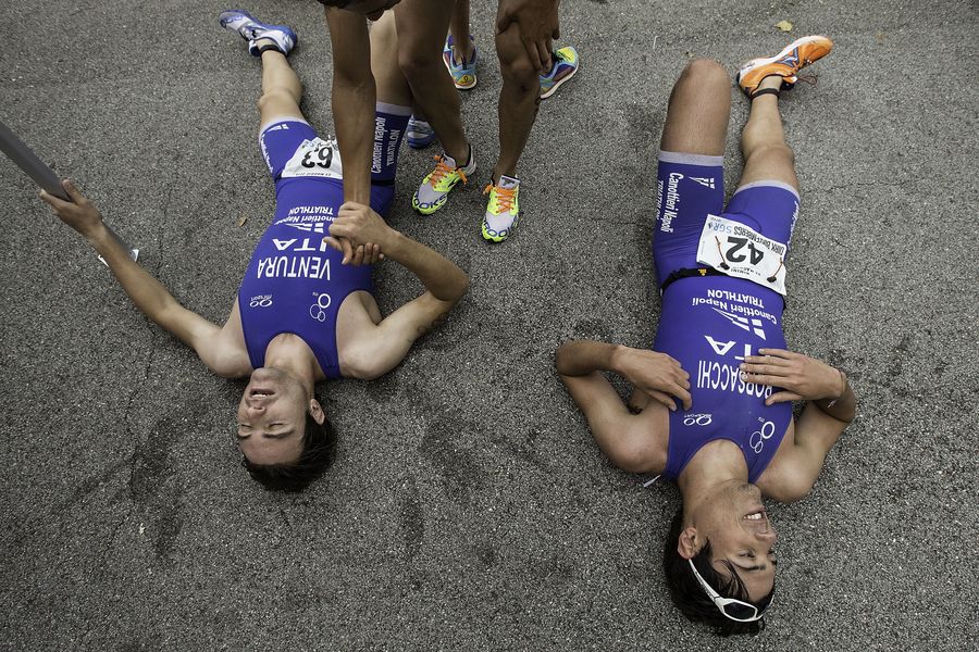 RIMINI, ITALY - MAY 23:  Athletes lies on the ground exhausted after finishing the Grand Prix Triathlon at the 2015 ETU Challenge Triathlon Rimini on May 23, 2015 in Rimini, Italy.  (Photo by Gonzalo Arroyo Moreno/Getty Images)